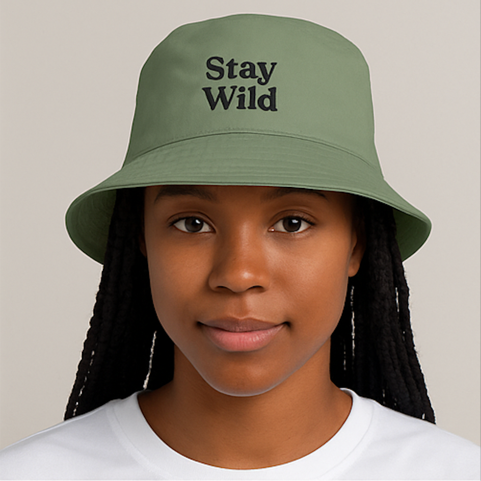 Girl wearing a embroidered bucket hat reading 'stay wild'